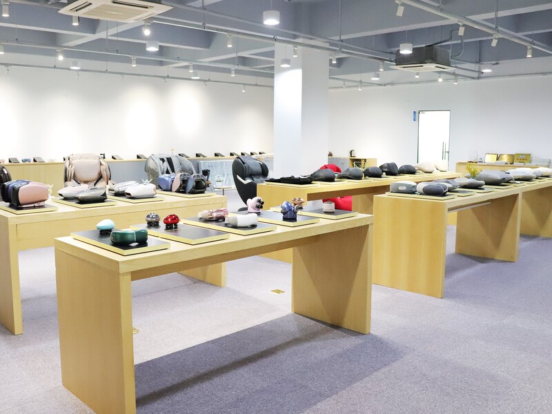 Massage products arranged on long display tables in the Forrest showroom.